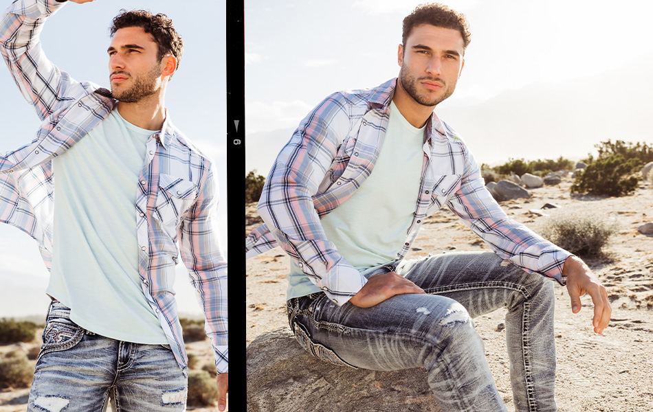 Shop All Men's Clothing - A guy wearing a blue and white plaid shirt over a light blue t-shirt with a pair of dark wash ripped jeans.